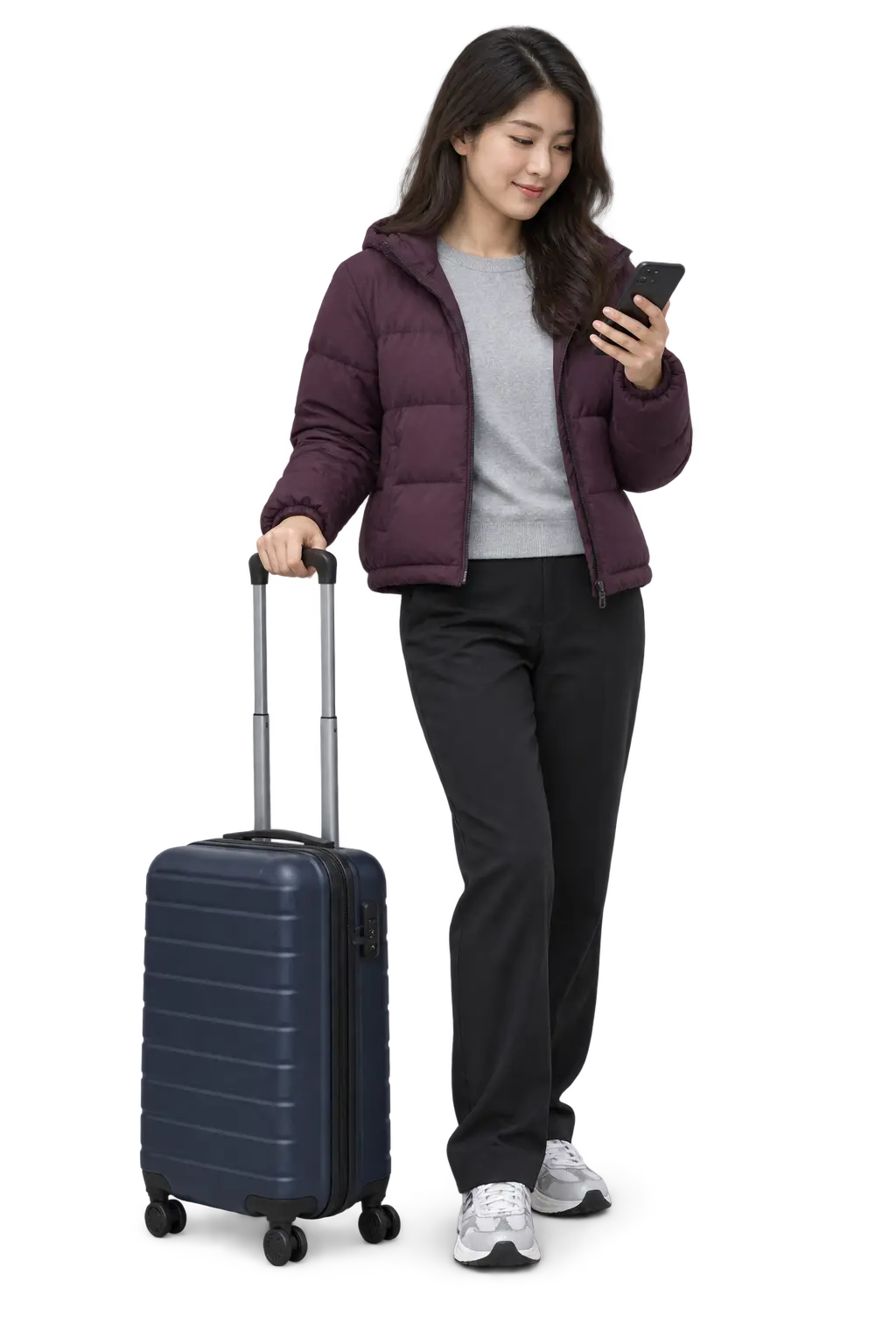 Traveller checking her phone beside a navy suitcase