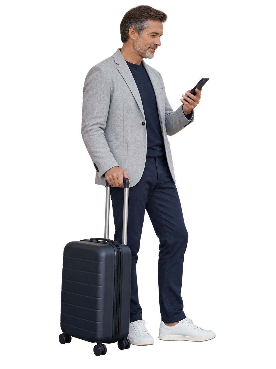 Man in a light grey jacket checking his phone beside a dark suitcase.