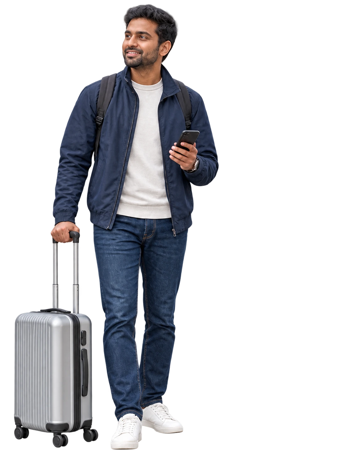 A traveller in a navy jacket checking a phone beside a silver suitcase