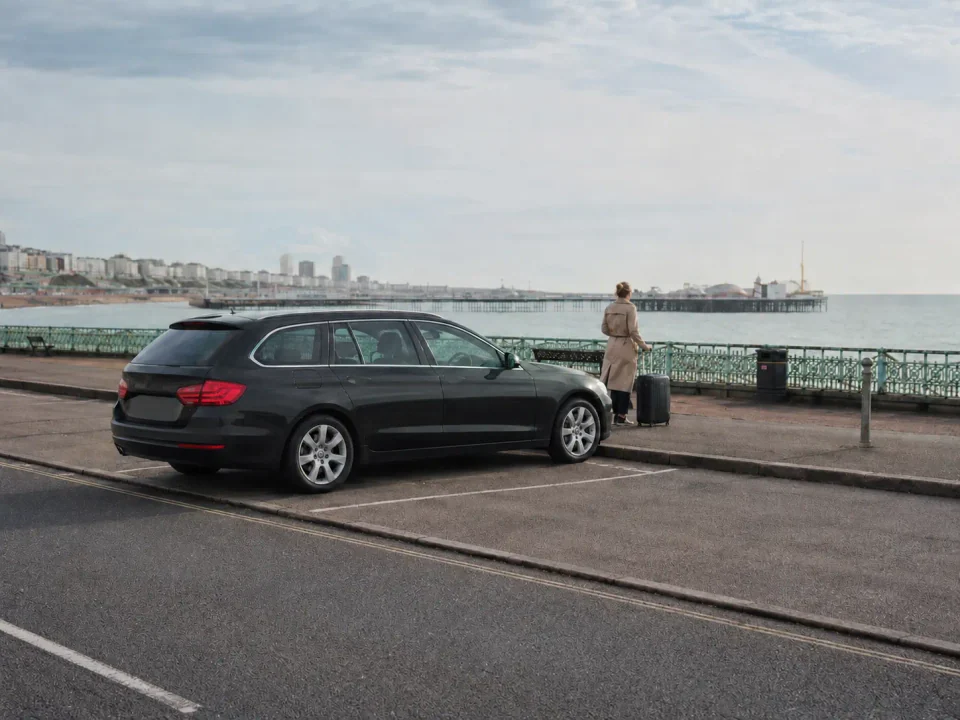 Airport transfer vehicle stopped at the kerb near Brighton seafront
