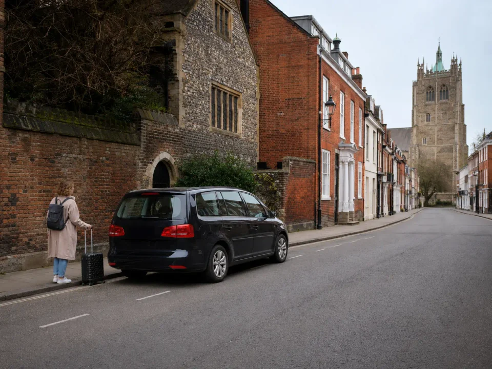 Airport transfer vehicle stopped at the kerb in Colchester
