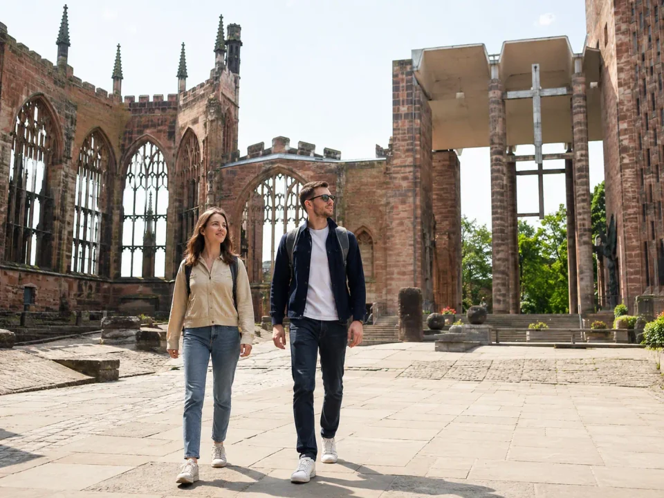 Visitors walking through the old cathedral ruins in Coventry