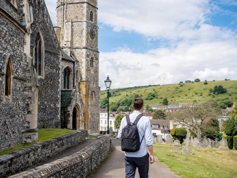 Traveller beside Dunstable Priory Church with the Chiltern Downs beyond