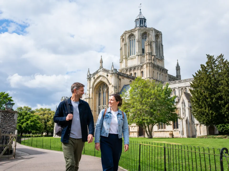 Visitors walking beside the cathedral in Ely