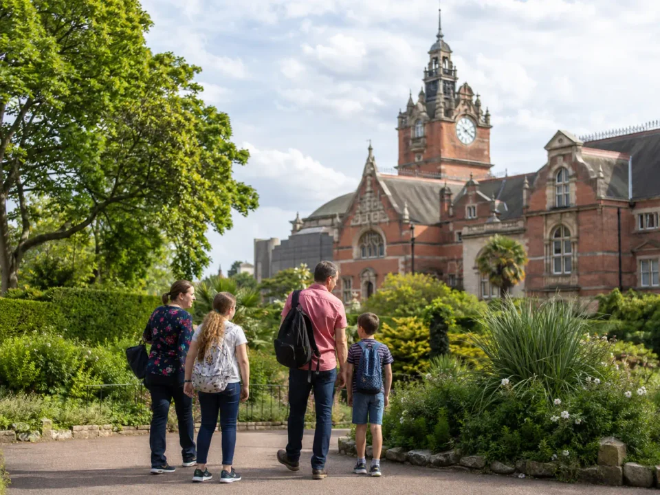 Family visitors in the gardens below the Horniman Museum clock tower in Forest Hill