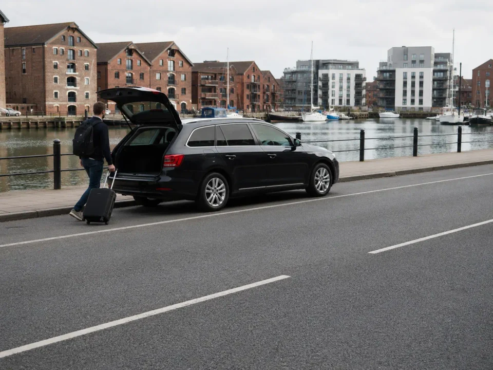 Airport transfer vehicle parked in a marked kerbside bay in Ipswich