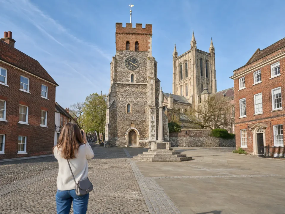 Traveller in historic St Albans with the clock tower and cathedral beyond