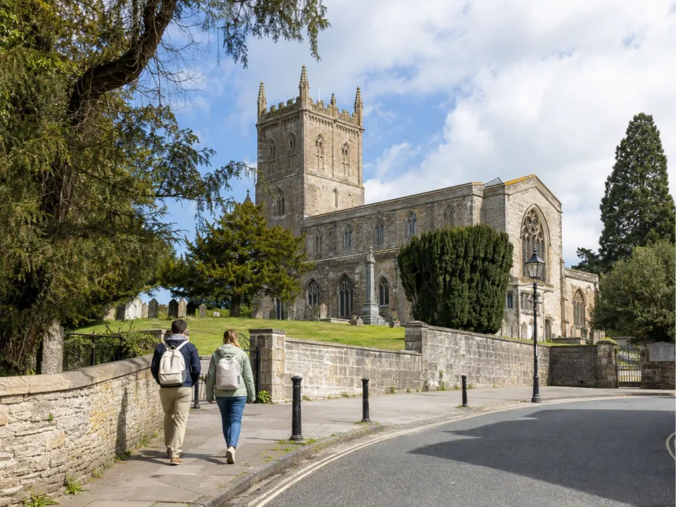 Visitors walking through the grounds beside St Asaph Cathedral