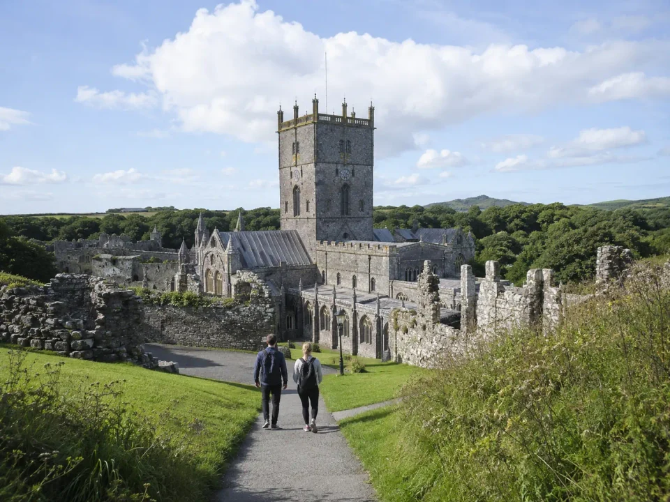 Visitors walking through the historic cathedral precinct at St Davids