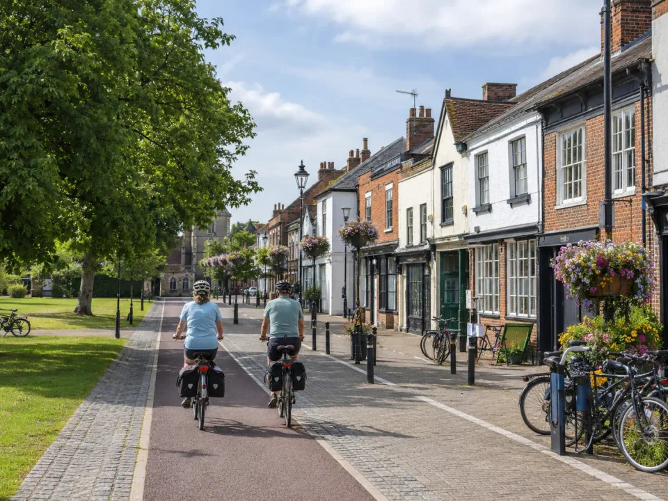 Cycle travellers passing the historic high street in Stevenage Old Town