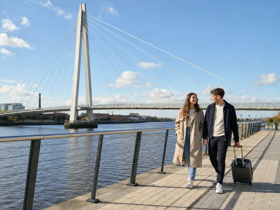 Business travellers walking beside the River Wear and bridge in Sunderland