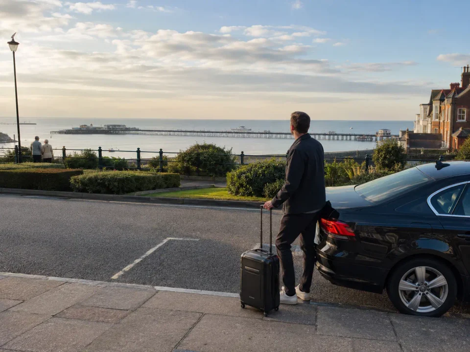 Airport transfer vehicle waiting at the kerb near Westcliff-on-Sea promenade