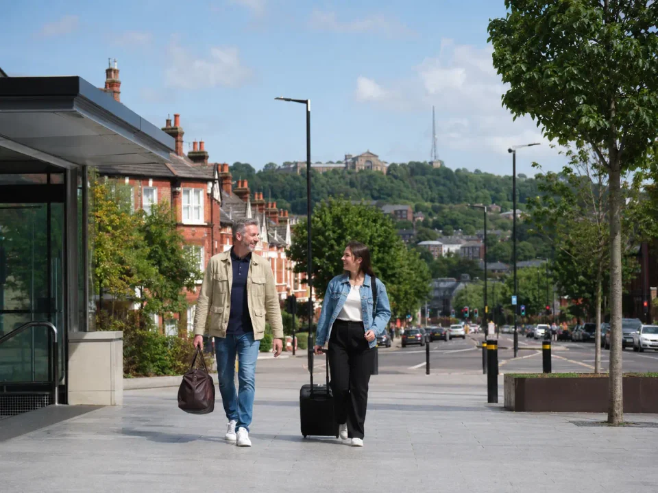 Travellers arriving in Wood Green with Alexandra Palace on the distant ridge