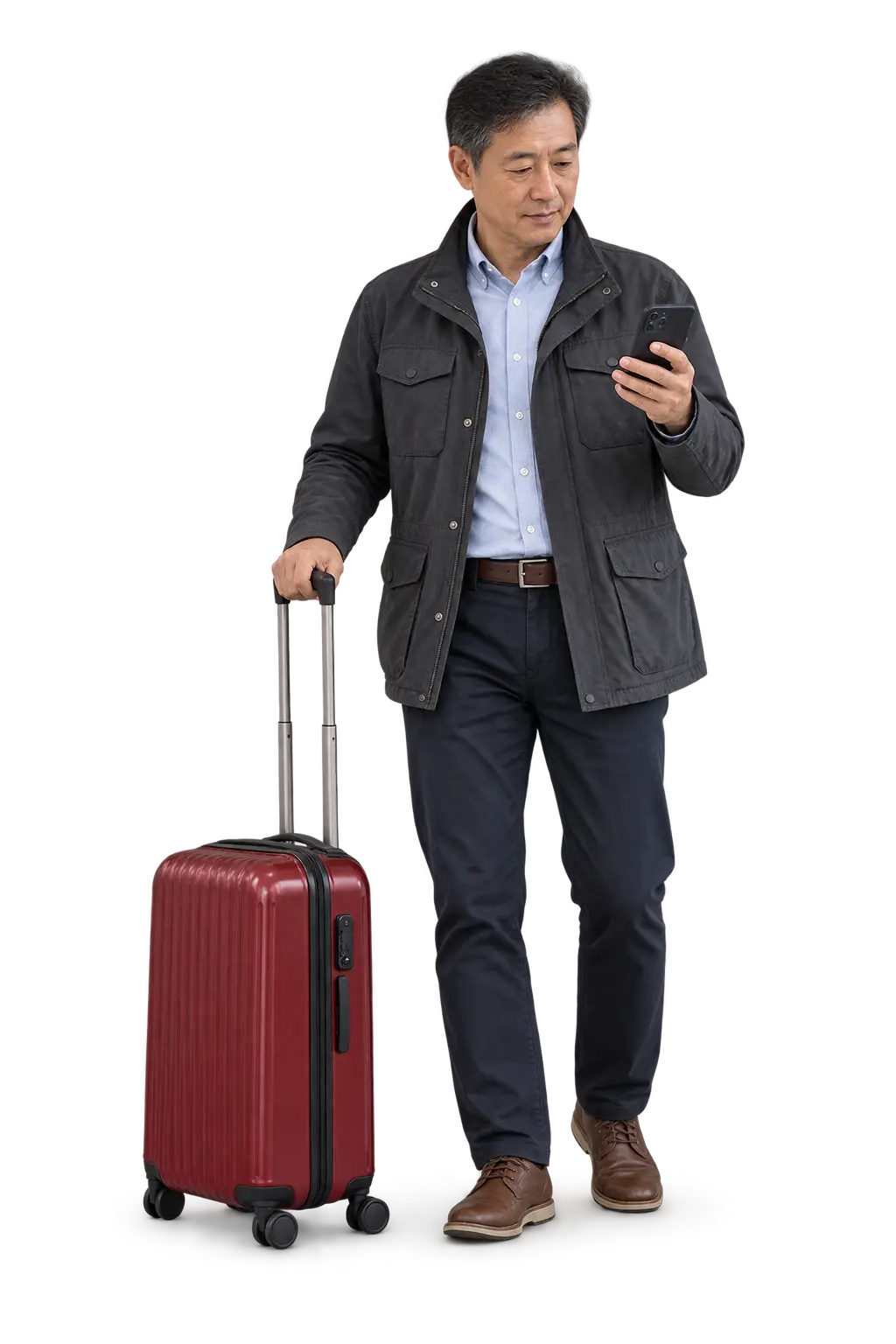 Traveller checking his phone beside a deep-red suitcase