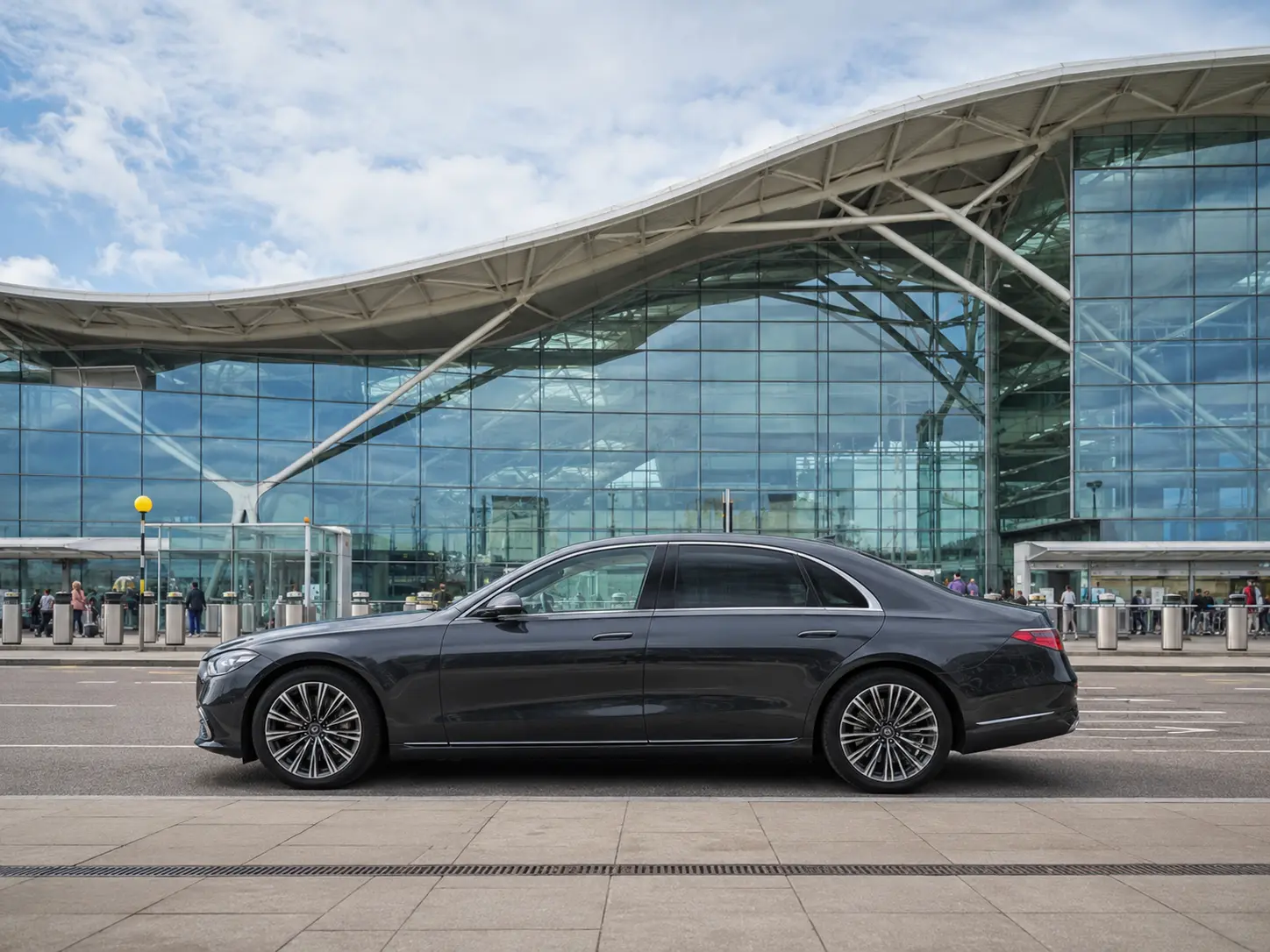 Executive saloon outside the curved glass and steel frontage of Heathrow Terminal 5