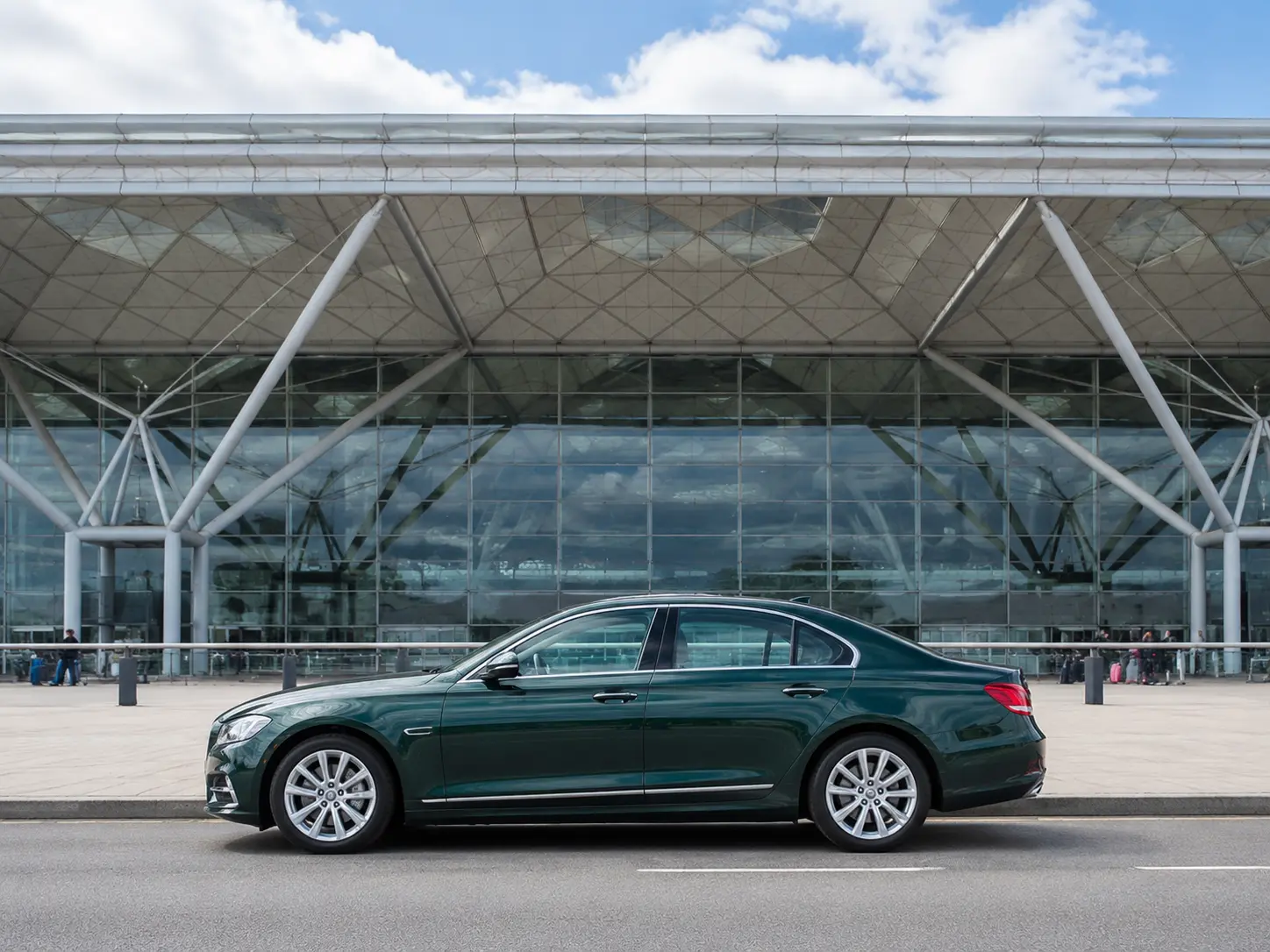 Executive saloon outside the glass and steel frontage of Stansted Airport